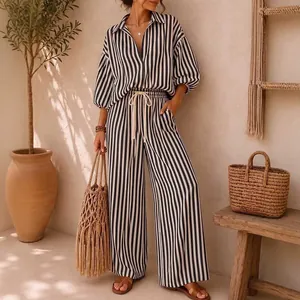 Detailed view of women's black and white striped resort-style shirt and wide-leg trousers.