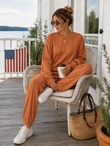 Fashionable orange cable-knit two-piece set for women featuring long sleeves and jogger pants