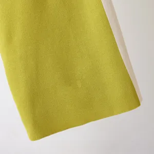Close-up detail showing the high-quality green and white contrast knit fabric texture