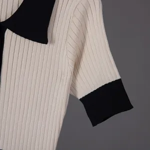 Detailed texture of the French vintage contrast color knit polo dress in cream and black