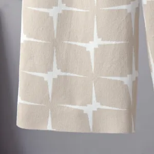 Close-up of geometric jacquard knit fabric showing intricate pattern and texture