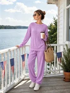 Lifestyle shot of woman in purple cable knit two-piece sweater set on scenic deck