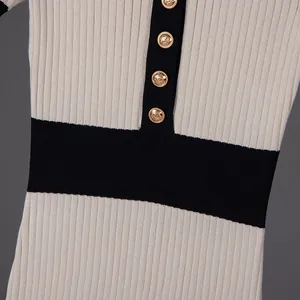 Close-up of French vintage knit dress with gold buttons and contrast collar detail.