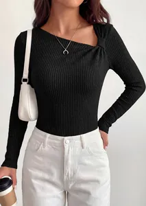 Detailed view of the black asymmetric knot shoulder on this ribbed long sleeve knit top