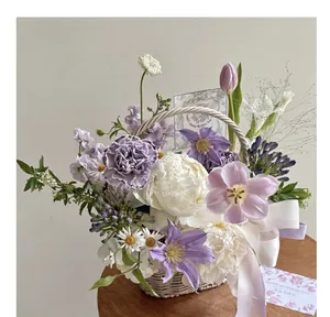 Detailed macro view of white woven rattan basket with purple carnations and tulips