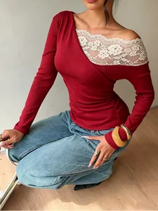 Detail of wine red ribbed long sleeve top with elegant white floral lace patchwork