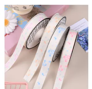 Detailed view of four matte ribbon rolls with elegant floral patterns for gift packaging.