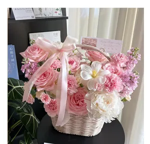 Detailed view of a handcrafted white wicker flower basket featuring pink floral decor