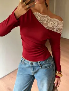 Close-up of a French style long sleeve top with cream lace patchwork and off-shoulder cut