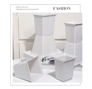 Close-up of white square plastic flower bouquet inserts and waterproof base supports.