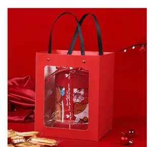 Detail view of a festive red New Year gift bag with a clear PVC window and handles