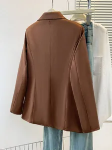 Detailed back view of a brown slim-fit professional blazer for women with clean seams.