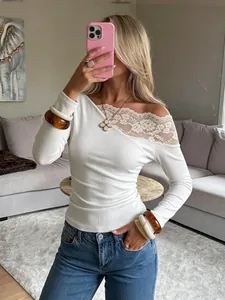 Detail of white off-shoulder T-shirt with delicate floral lace trim on the neckline