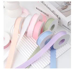 Macro view of multi-colored double-sided matte satin ribbons for gift wrapping and DIY bows