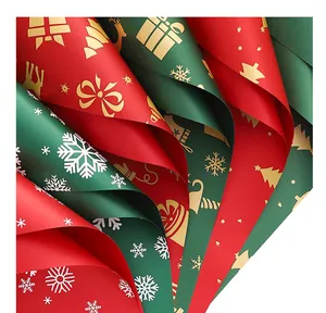 Detailed view of red and green waterproof Christmas wrapping paper with festive patterns