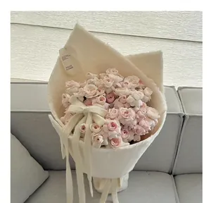 Close-up van roze rozen verpakt in zachte gebroken witte pluche gevlokte stof voor