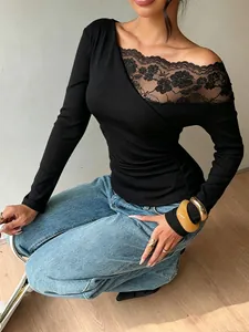 Detailed view of a black long sleeve tee with elegant lace patchwork and cold shoulder.
