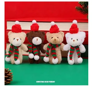 Close-up view of four Christmas plush teddy bears wearing red hats and scarves
