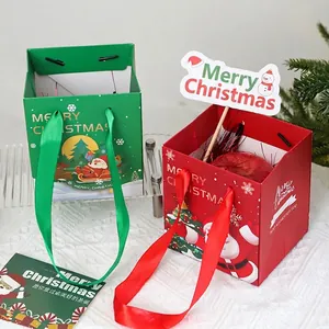 Dos bolsas de regalo de Navidad festivas de papel con asas de cinta y diseños de Paño Noel
