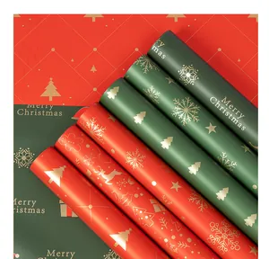Close-up of waterproof Christmas wrapping paper with gold snowflakes and deer patterns.