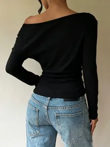 Detailed back view of a chic French style black off-the-shoulder long sleeve slim fit top