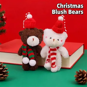 Two adorable Christmas plush bears with red hats and scarves on festive background
