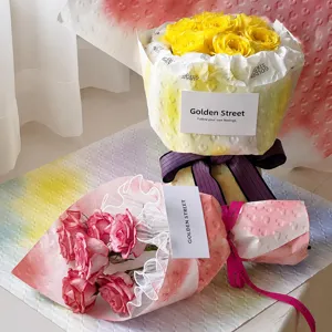 Detail view of yellow and pink roses colored with professional floral spray dye