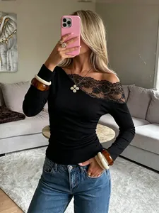 Close-up of black long sleeve T-shirt featuring French lace splicing on asymmetrical shoulder.