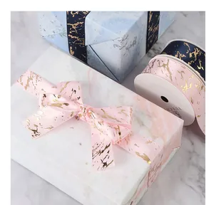 Close-up of pink marble ribbon with gold foil detail on a gift box