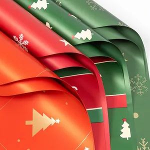 Waterproof Christmas wrapping paper in red and green with festive gold tree patterns