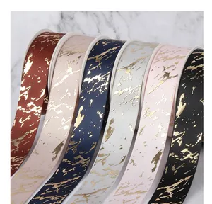 Detailed macro view showing six colors of 2.5cm ribbons with elegant gold marble patterns
