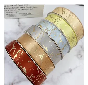 Detailed close-up of colorful marble pattern ribbons with gold foil splashing effect