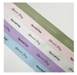 Close-up of grosgrain ribbon with "Special Day" print in various pastel colors.