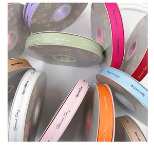 Close-up of colorful grosgrain ribbons with "Special Day" print for gift wrapping.