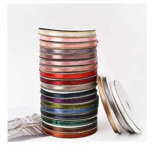 Vibrant stack of 1cm gold-edged satin ribbons perfect for bouquet and gift packaging crafts.