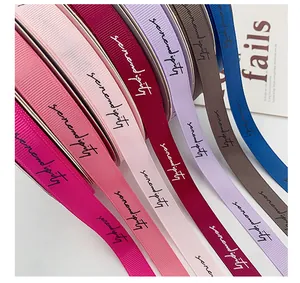 Close-up of colorful grosgrain ribbons with 'Serendipity' script for gift wrapping