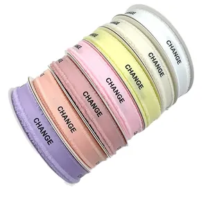Frayed edge grosgrain ribbons in assorted colors with 'CHANGE' print for gift wrapping