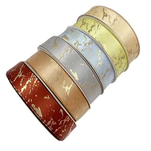Premium 2.5cm marble pattern satin ribbon with gold foil detailing for elegant gift wrapping