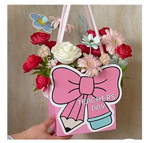 Detailed view of pink Teachers' Day flower gift box with a large bow and pencil design