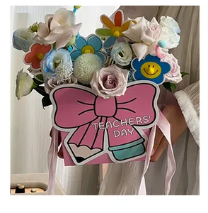 Detail of pink bow-shaped flower gift box with Teachers' Day message and pencil design