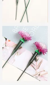 Close-up of green plastic flower water vials with long stems for fresh floral arrangements.