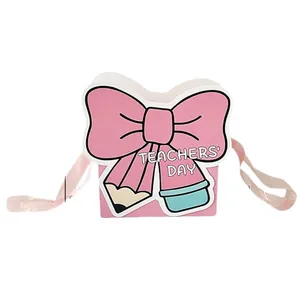 Pink bow-shaped Teachers' Day gift box with creative pencil design and ribbon handles