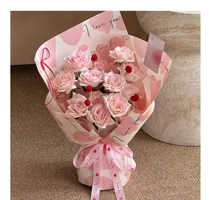 Close-up of pink rose bouquet with heart patterned ribbons for gift wrapping