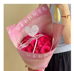 Detailed close-up of a heart-shaped message card in a bright pink rose bouquet gift.