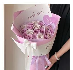 Detail view of heart-shaped greeting card on a purple rose bouquet for Valentine's Day