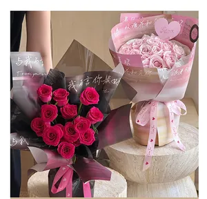Detail of two rose bouquets with elegant gradient wrapping and I love you heart ribbons