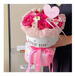 Detail view of pink flower gift box packaging with LOVE YOU ribbon and heart card