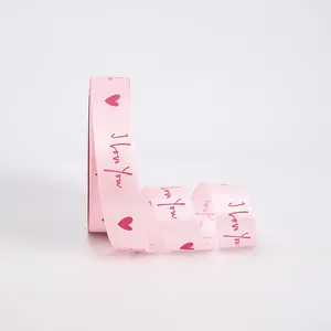 Pink satin ribbon with red heart and I Love You prints for Valentines gift wrapping.