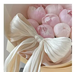 Detailed close-up of a pearly lustre satin fabric bow for floral bouquet decoration
