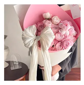 Close-up of a French pearlescent fabric bow used as a romantic flower bouquet decoration